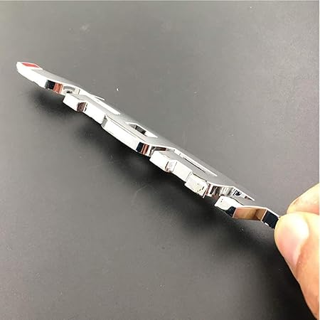 Metallic object held by a hand on a dark background