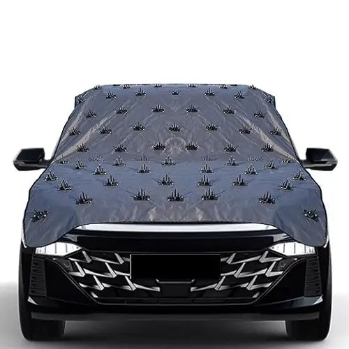 Front view of a black vehicle fitted with a heavy-duty anti-animal spiked car cover, featuring evenly spaced deterrent spikes across the hood and windshield to prevent climbing and scratching.