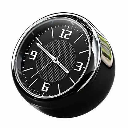 Mini round car dashboard clock featuring a black dial with a carbon fiber textured center, crisp white numerals, and a polished chrome rim, designed as a sleek automotive interior accessory.
