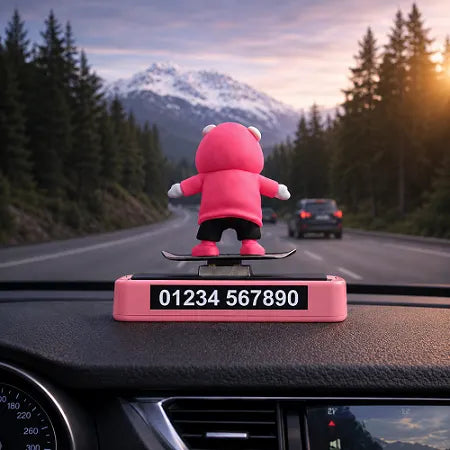 Back view of the sliding panda car dashboard accessory featuring a built-in temporary parking phone number card on the pink base, displayed prominently in the front windshield window.