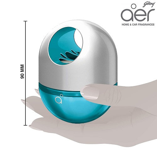 Blue and silver aero home and car fragrance device held by a hand, with 'aer' branding.