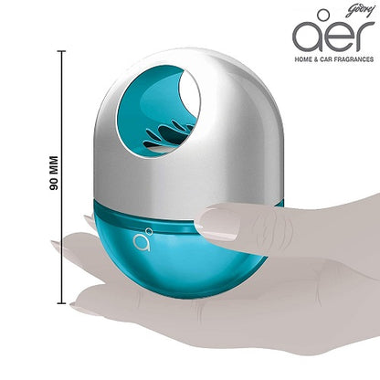 Blue and silver aero home and car fragrance device held by a hand, with 'aer' branding.