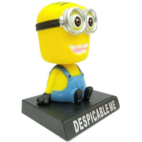 Angled front view of a cute Minion shaking head toy, a decorative interior accessory for car dashboards.