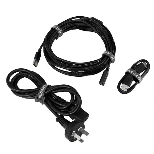 Various black power cords, extension cables, and USB wires neatly coiled and organized using black Florican reusable cable straps.