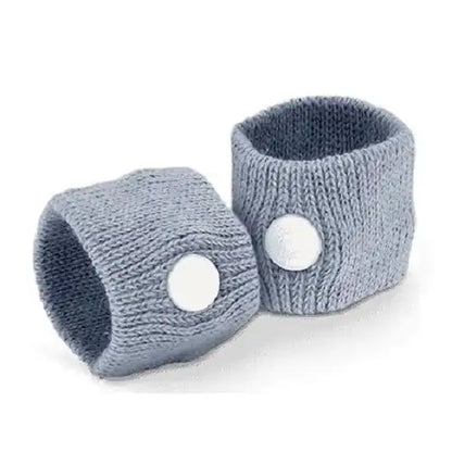A pack of 2 grey knit motion sickness acupressure bands standing upright, highlighting the integrated white plastic buttons that apply targeted pressure to the wrist for natural nausea relief.