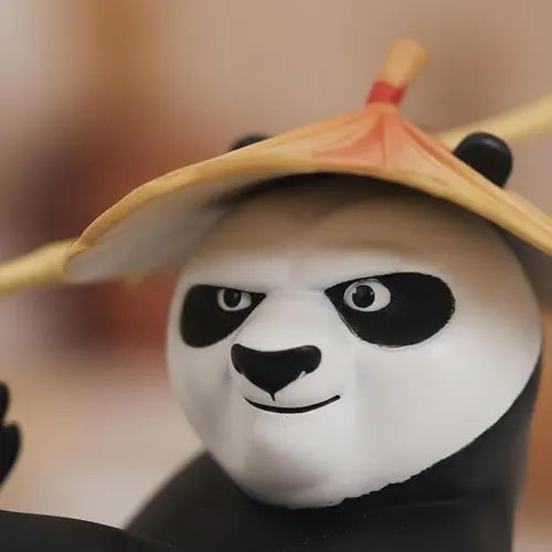 Extreme close-up of the Kung Fu Panda dashboard accessory, detailing the character's signature determined facial expression, painted eyes, and the sculpted texture of the straw hat.