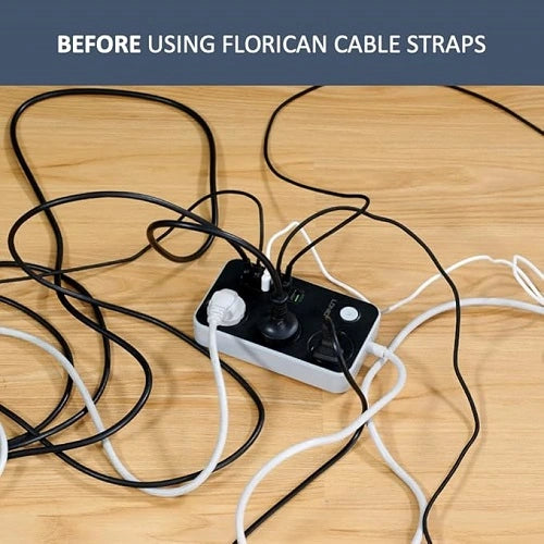 A messy, tangled pile of power cords and cables plugged into a power strip on a wooden floor, demonstrating the clutter before using Florican cable straps for wire management.