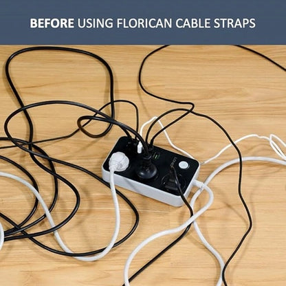 A messy, tangled pile of power cords and cables plugged into a power strip on a wooden floor, demonstrating the clutter before using Florican cable straps for wire management.