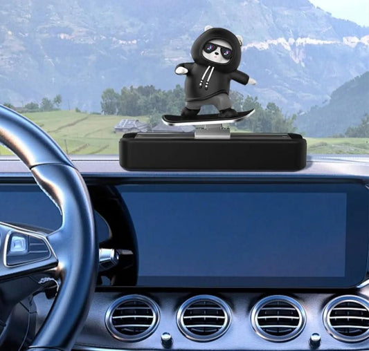 Car dashboard with a panda skateboard car décor toy on a stand, scenic background