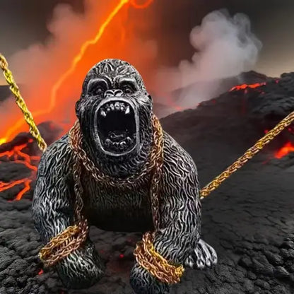 A roaring silver silverback gorilla auto interior decoration figure wrapped in gold chains, set against a dramatic, fiery volcano background.