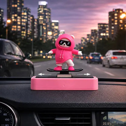 Front view of a cute pink panda on a skateboard sliding car dashboard ornament. White arrows indicate the kinetic left and right sliding motion of the figure as the car turns.