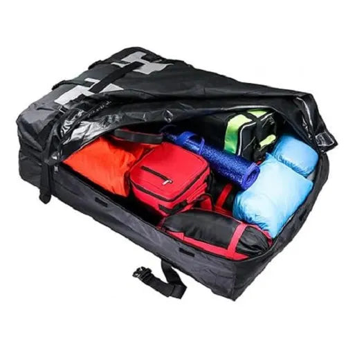 An open Velura 15 cubic feet rooftop cargo carrier bag demonstrating its massive luggage storage capacity, fully packed with colorful travel bags, camping gear, and a yoga mat.