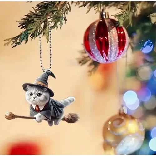 The versatile wizard cat car mirror charm doubling as a festive holiday decoration, hanging on a Christmas tree branch next to a red bauble.